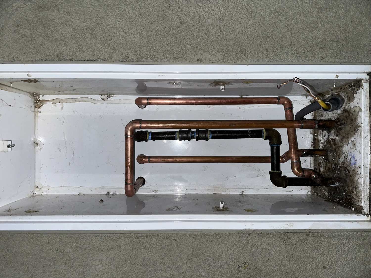 Rerouted copper water and gas lines roughed into the wall cavity for a tank-to-tankless conversion in Lincoln, CA